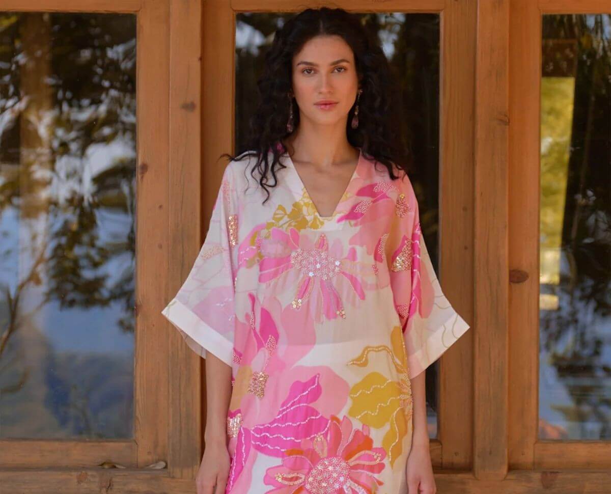 White and pink silk tunic with hand sequin embroidery wild rose floral print and color blocked pants.